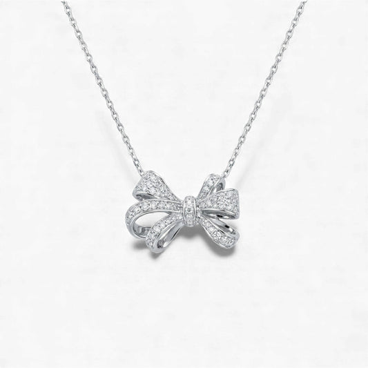 Silver bow-shaped necklace on a white background