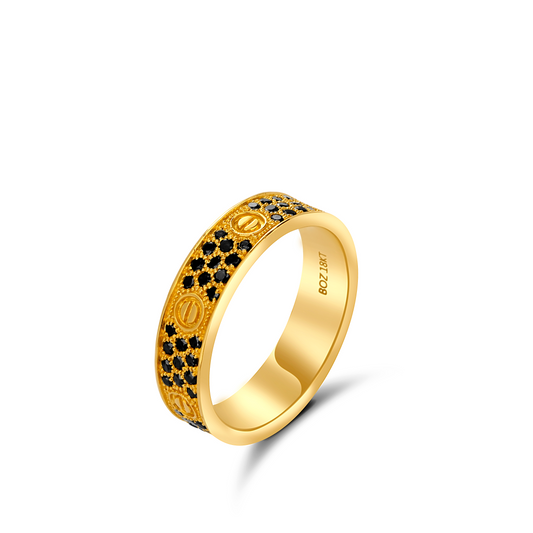 Gold ring with black gemstones on a white background