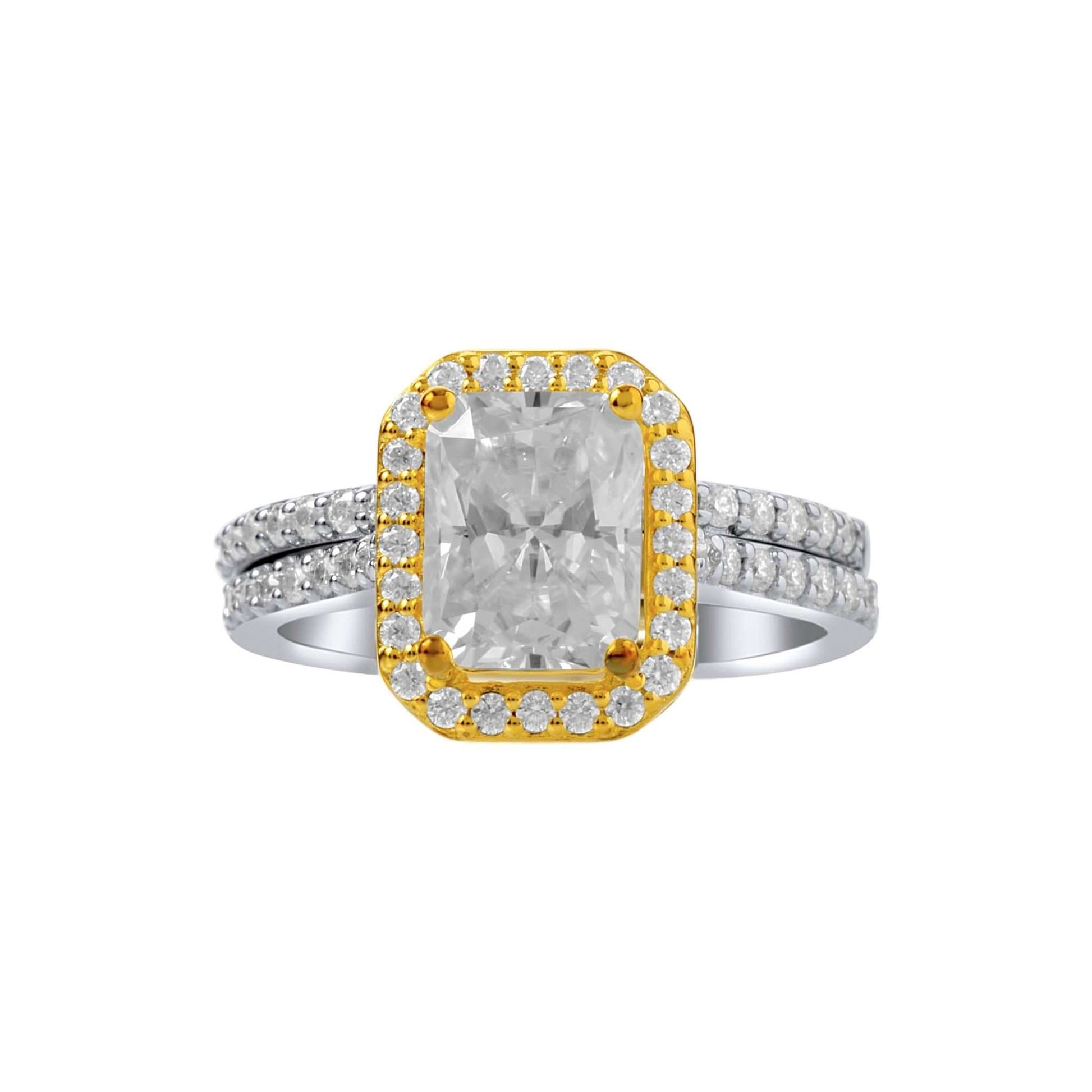 Two-tone ring with a large central diamond and smaller diamonds on a white background
