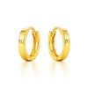 Gold hoop earrings on a white background
