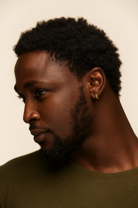 Man with a gold earring against a beige background
