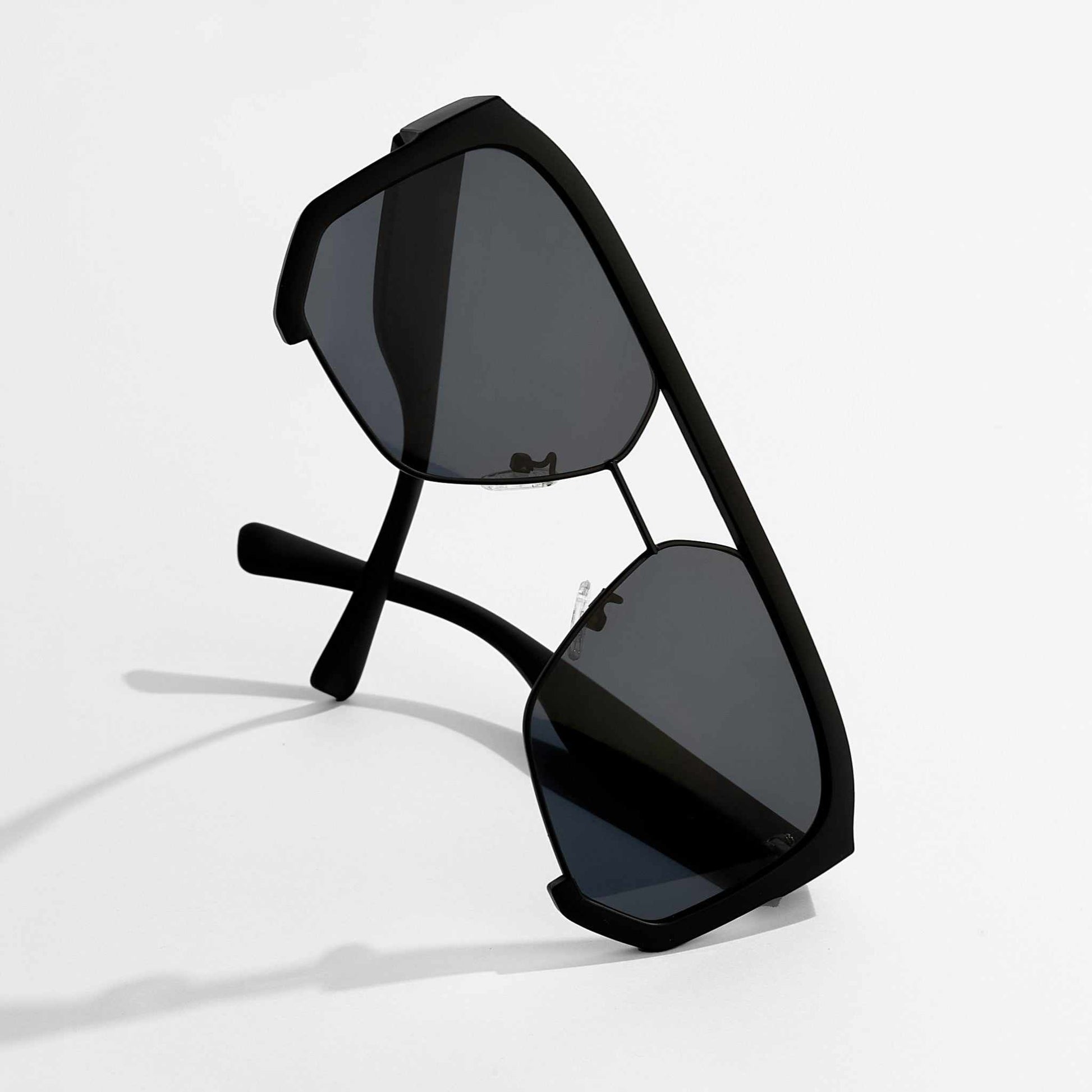 Black sunglasses with reflective lenses on a white background