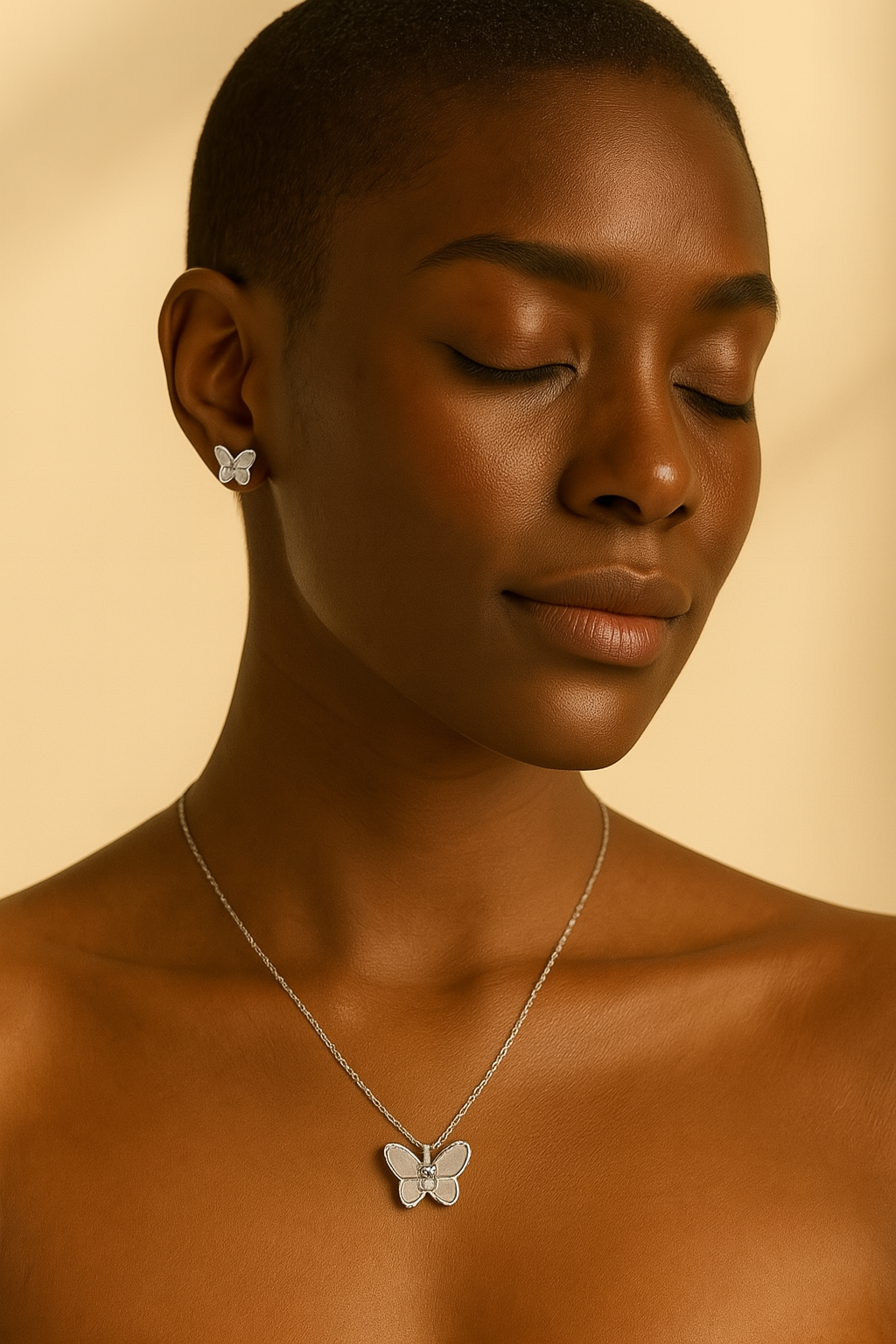 Woman wearing a butterfly necklace and earrings against a beige background