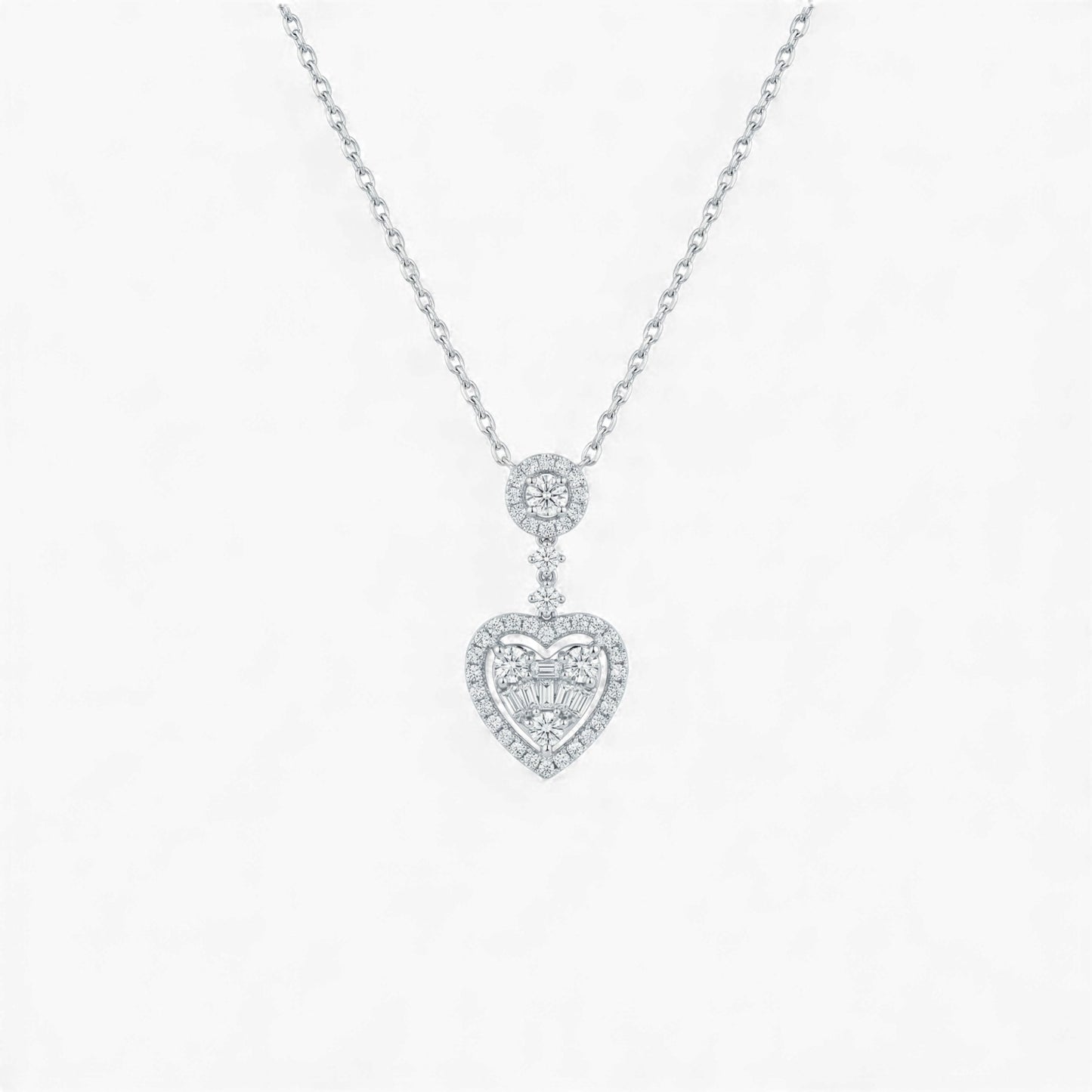 Heart-shaped diamond pendant on a chain against a white background