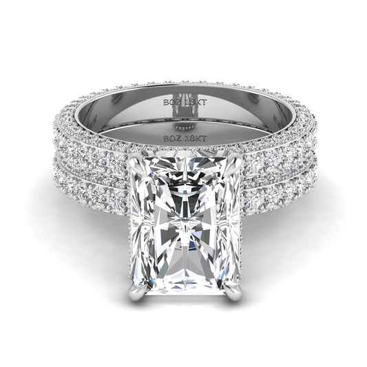 A bride's ring set featuring a radiant cut diamond on a white gold band, with additional smaller diamonds set around the band.