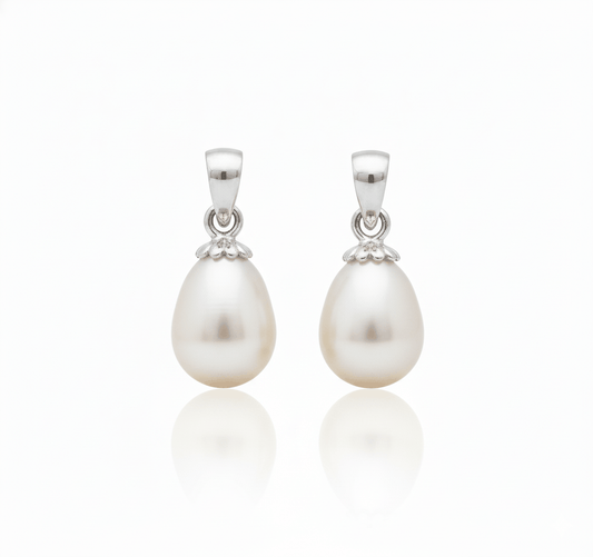 Pair of natural pearl pendants with 18KT gold setting, elegant and minimalist design.