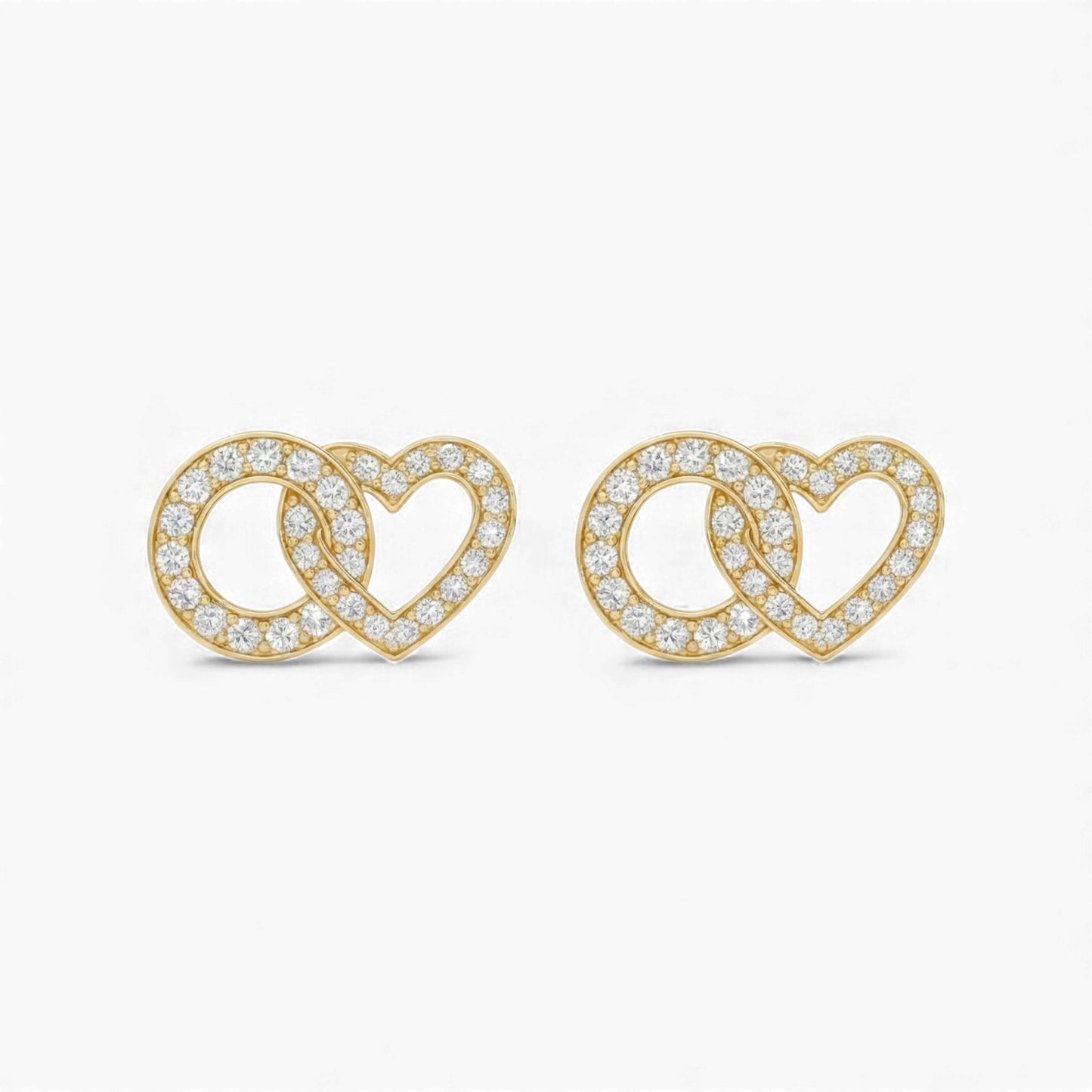 Gold heart-shaped earrings with clear stones on a white background