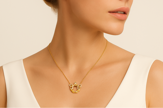 Woman wearing a gold necklace against a beige background