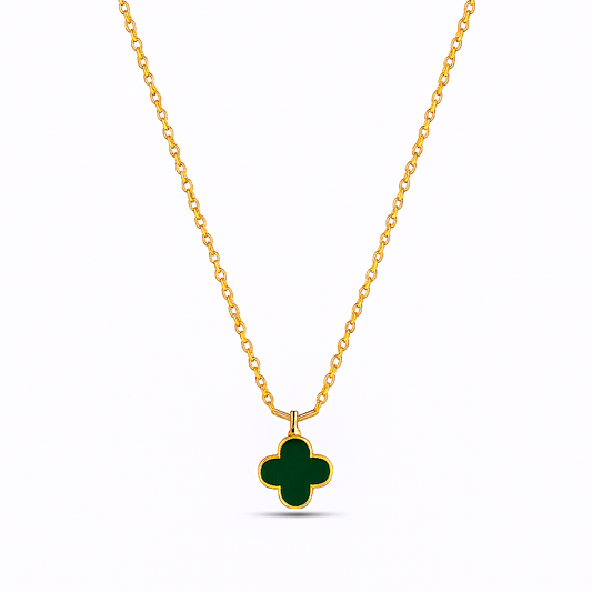 Gold necklace with a green clover pendant on a white background
