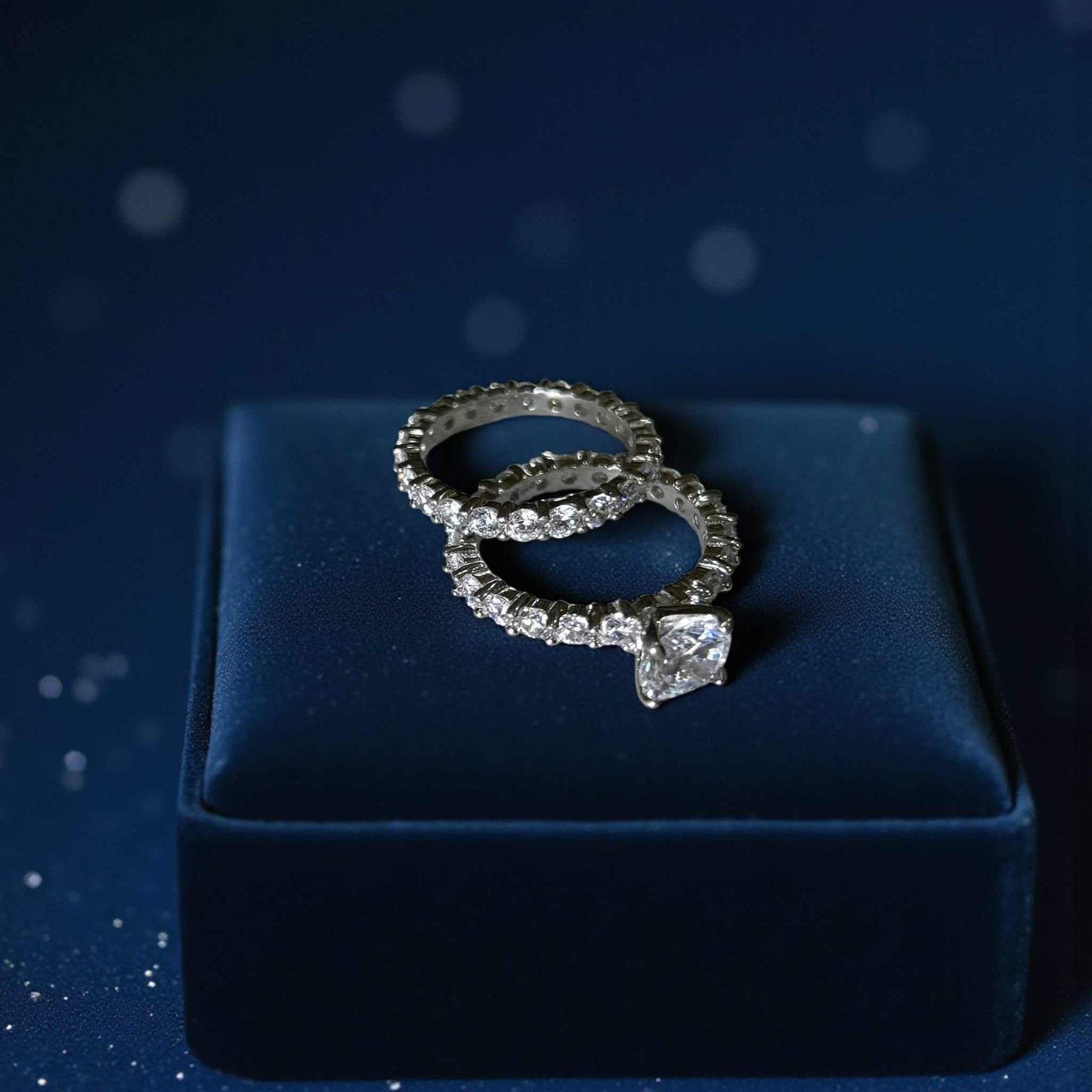 Vega Round CZ Bride Set featuring 925 sterling silver rings with round cubic zirconia center stone and halo accents on a navy velvet box