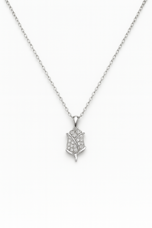 Silver necklace with a leaf-shaped pendant on a white background