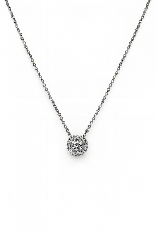 Silver necklace with a round pendant on a white background