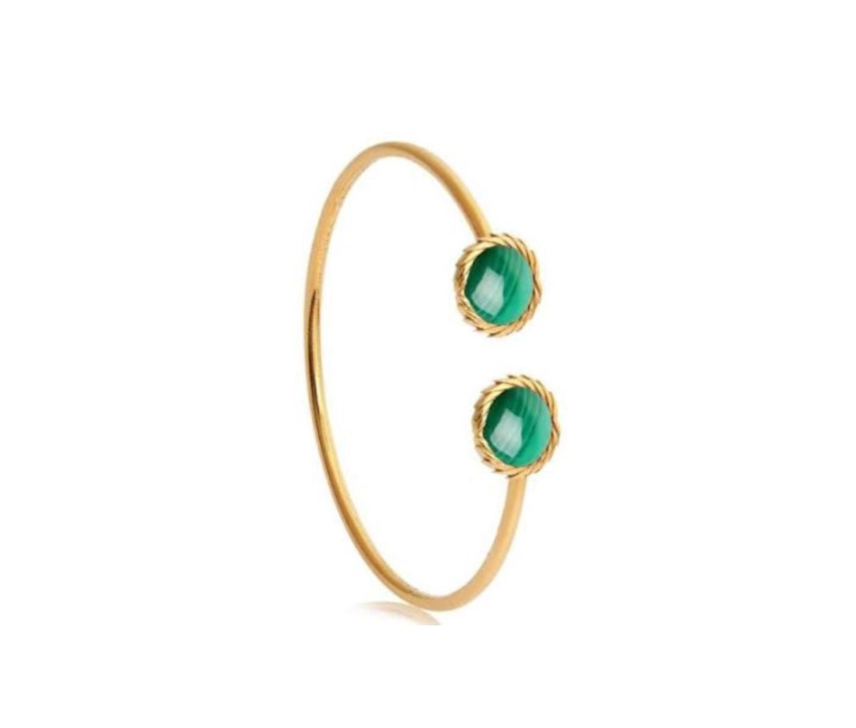 Gold bangle with green gemstones on a white background