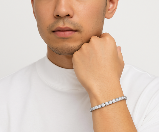 Man wearing a diamond bracelet on a plain background