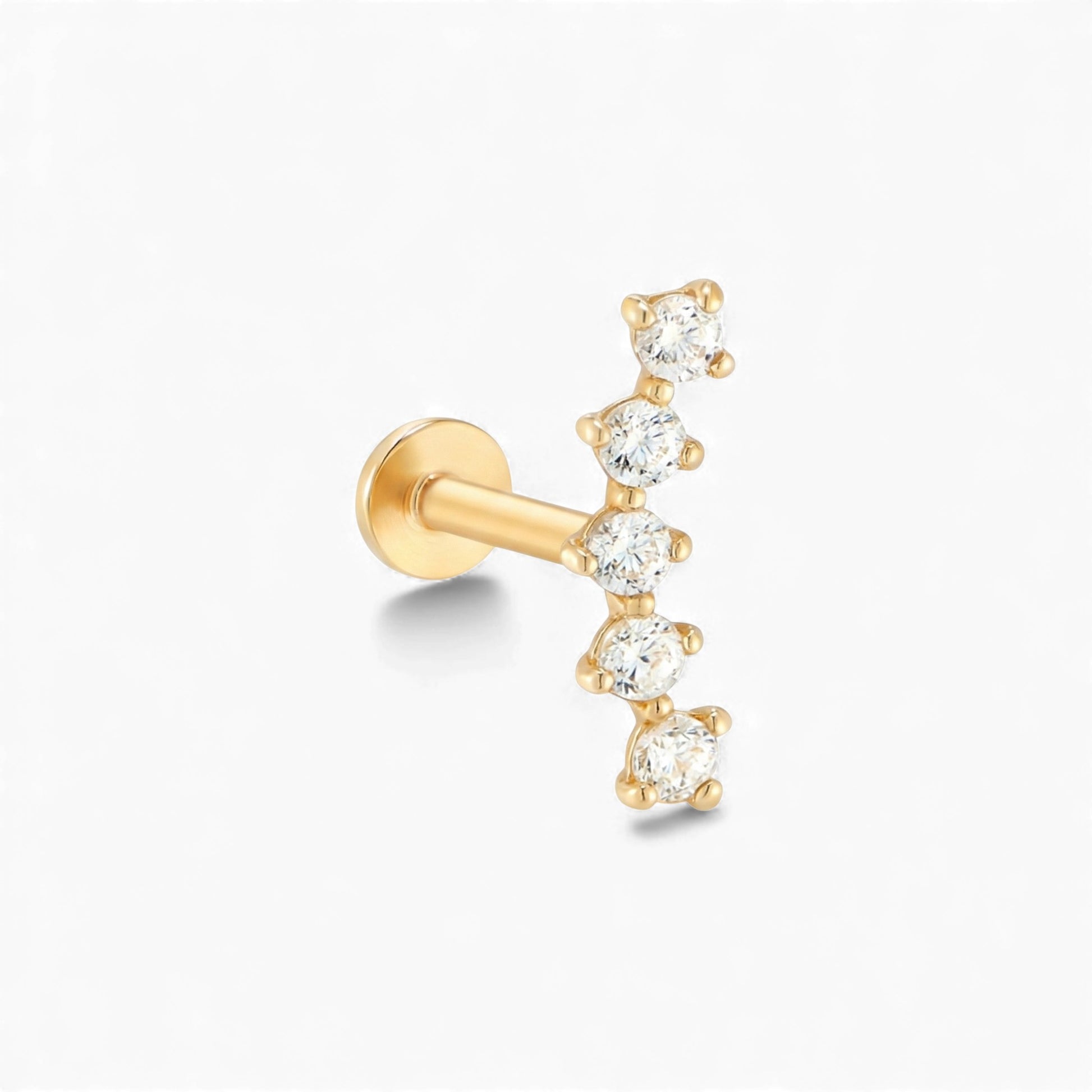 Gold earring with clear gemstones on a white background
