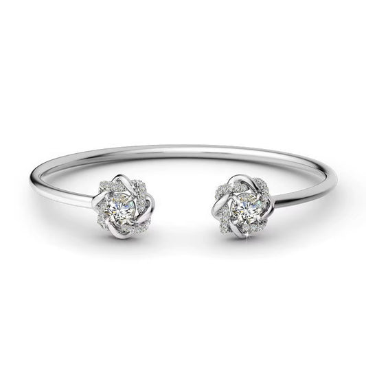 Pair of silver earrings with diamond-like stones on a white background