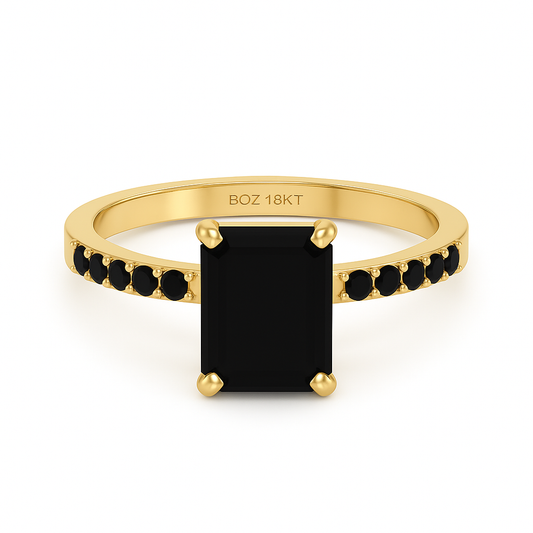 Gold ring with a black gemstone on a white background