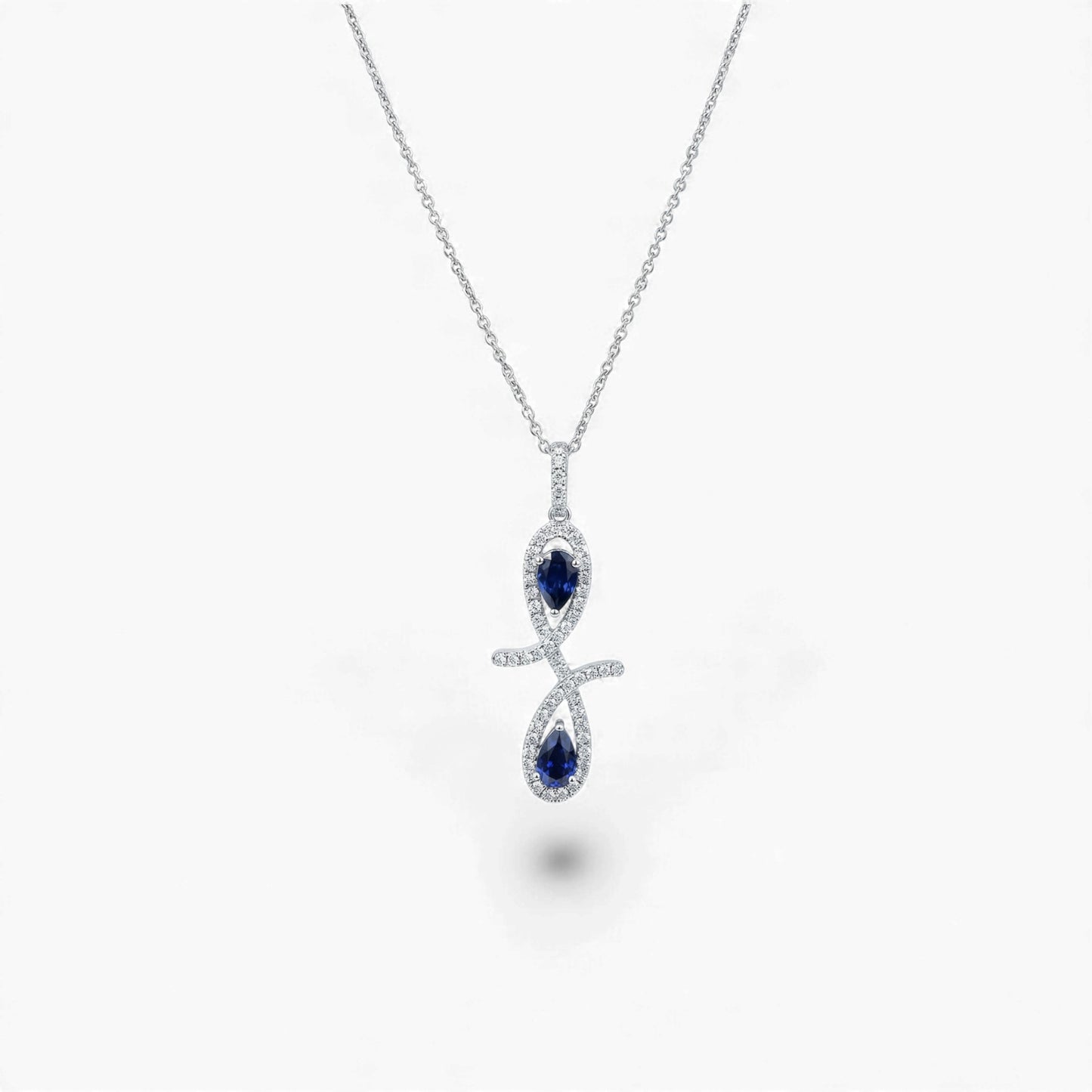 Silver necklace with a blue gemstone pendant on a white background