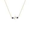 Gold necklace with a fish-shaped pendant featuring blue stones on a white background