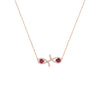 Rose gold necklace with a fish-shaped pendant featuring red gemstones on a white background