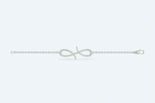 Silver bracelet with a bow design on a light gray background