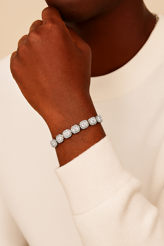 Silver bracelet on a wrist with a neutral background