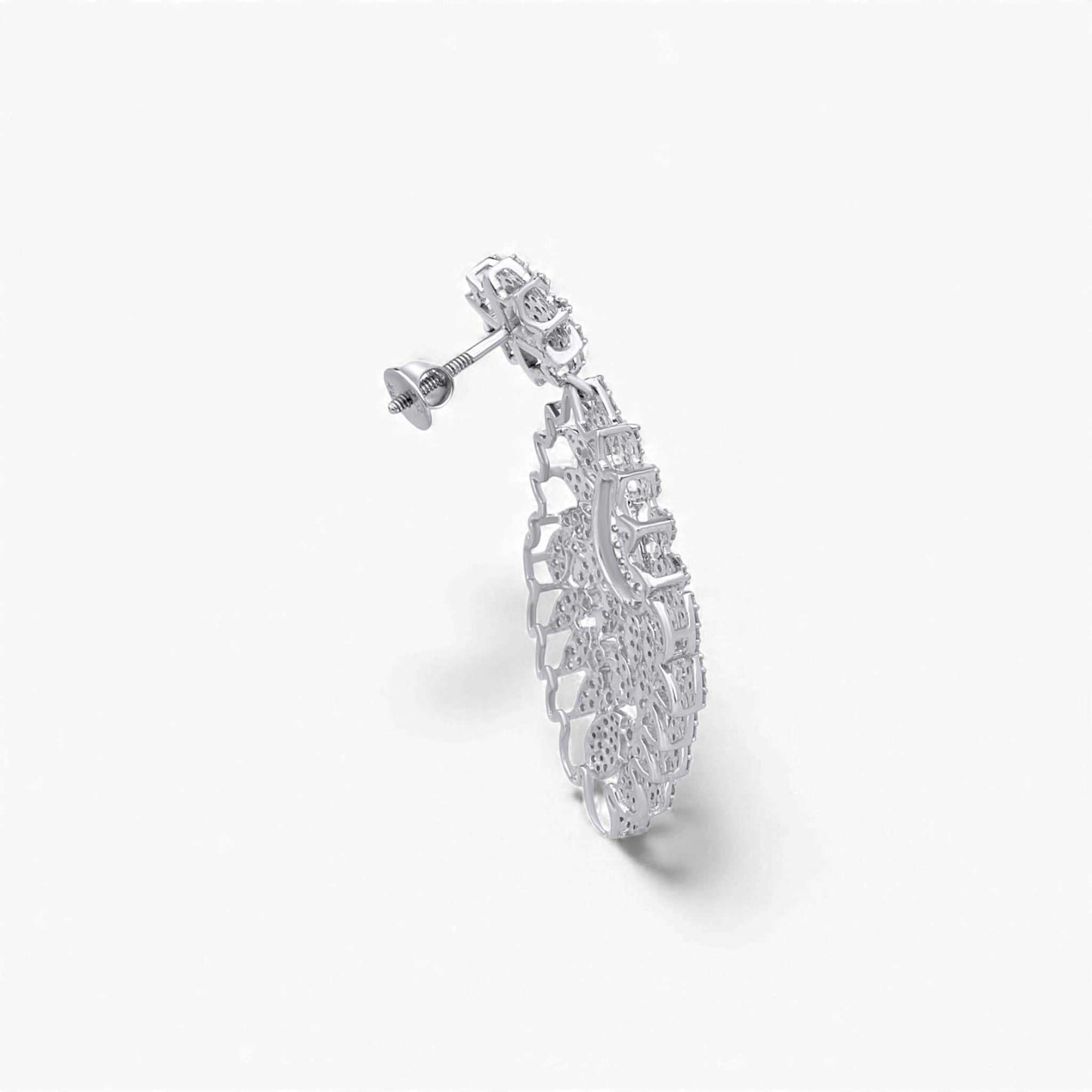 Silver earring with intricate design on a white background