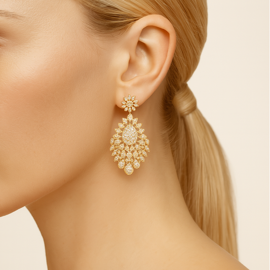 Close-up of a woman wearing a gold earring with a beige background