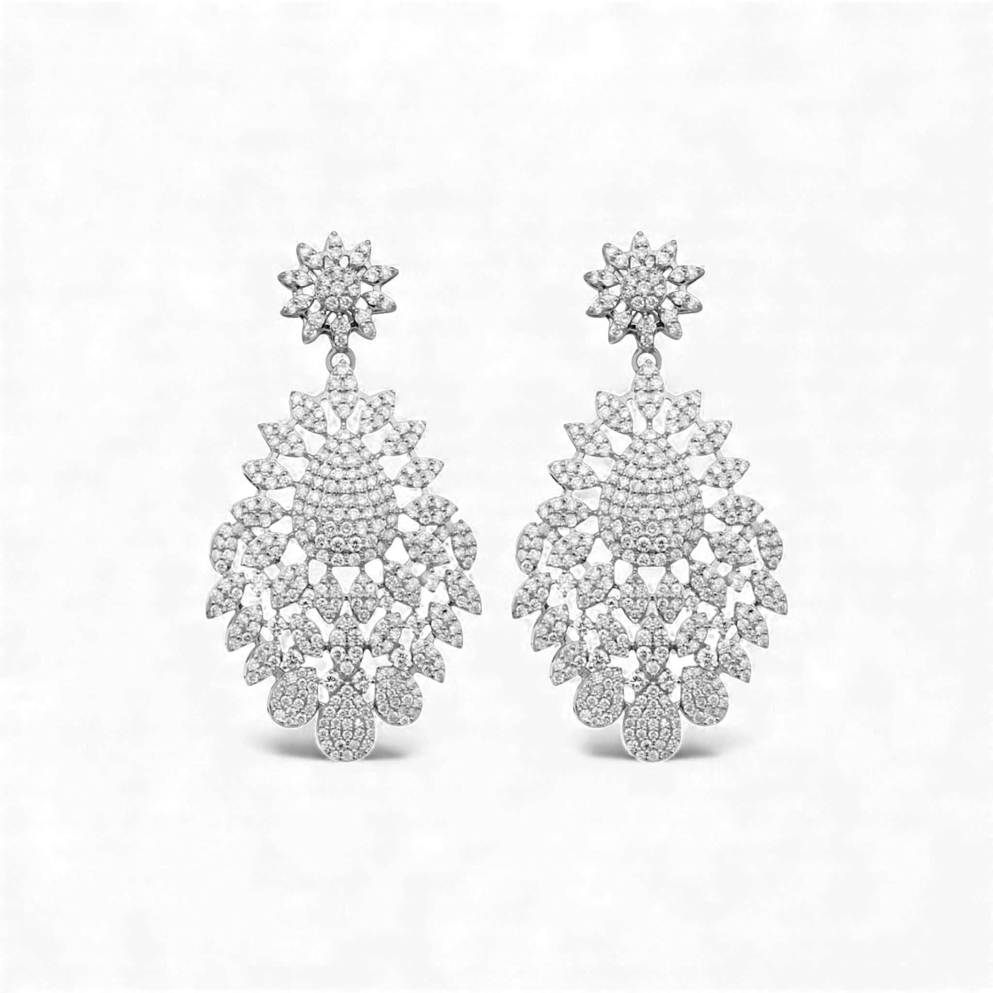 Pair of silver chandelier earrings on a white background