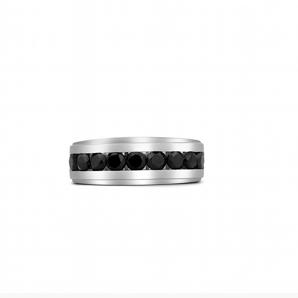 Silver ring with black gemstones on a white background