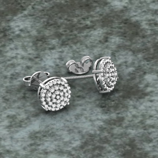 A pair of 18 karat gold diamond cluster stud earrings on a textured background.