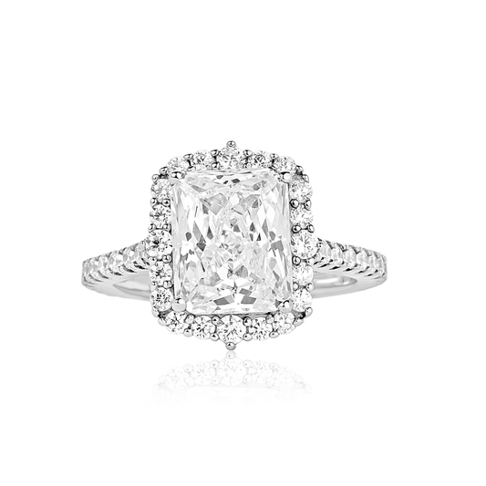 Diamond ring with a rectangular center stone on a white background