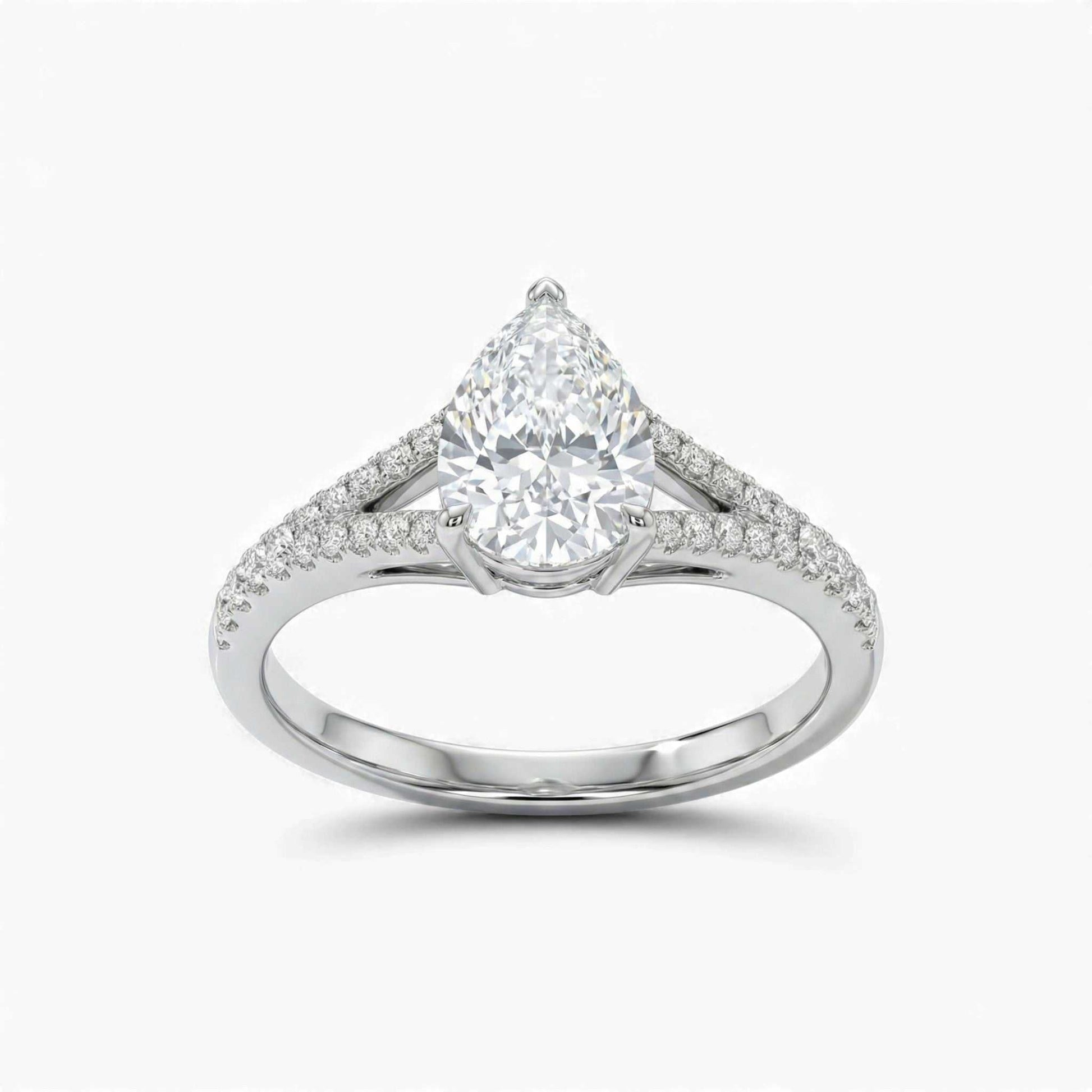 Diamond ring with a pear-shaped center stone on a white background
