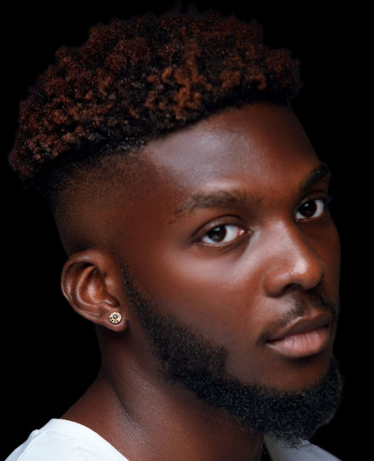 A person with black diamonds stud earrings.