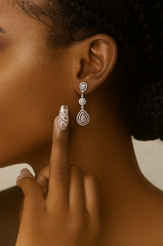 Close-up of a person wearing a silver earring with a blurred background