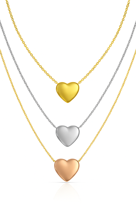 Three heart-shaped pendants on gold, silver, and rose gold necklaces against a white background.