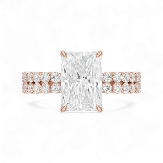 Rose gold ring with a large diamond and smaller diamonds on the band against a white background