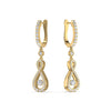 A pair of 18 karat gold hoop earrings with intricate designs and adorned with diamonds.