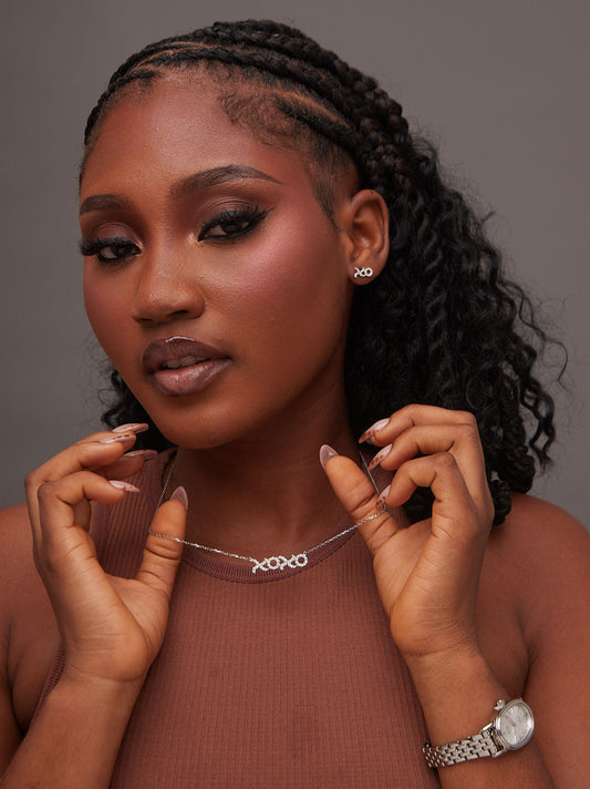 Woman wearing a necklace with a neutral background