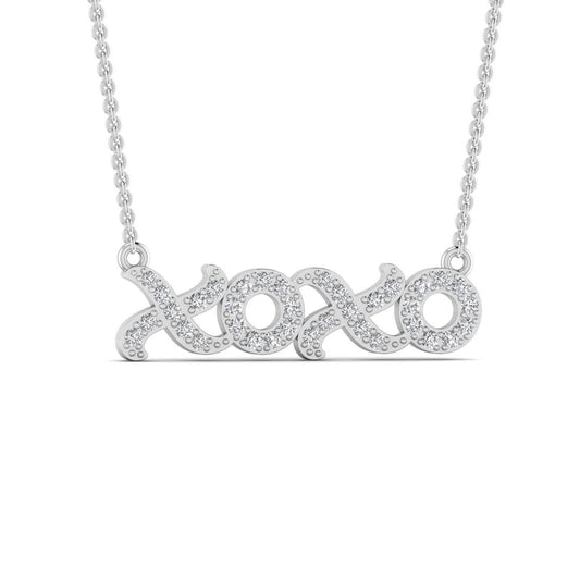 A 18 karat gold necklace with a natural diamond pendant in the shape of the letters 'XO'.