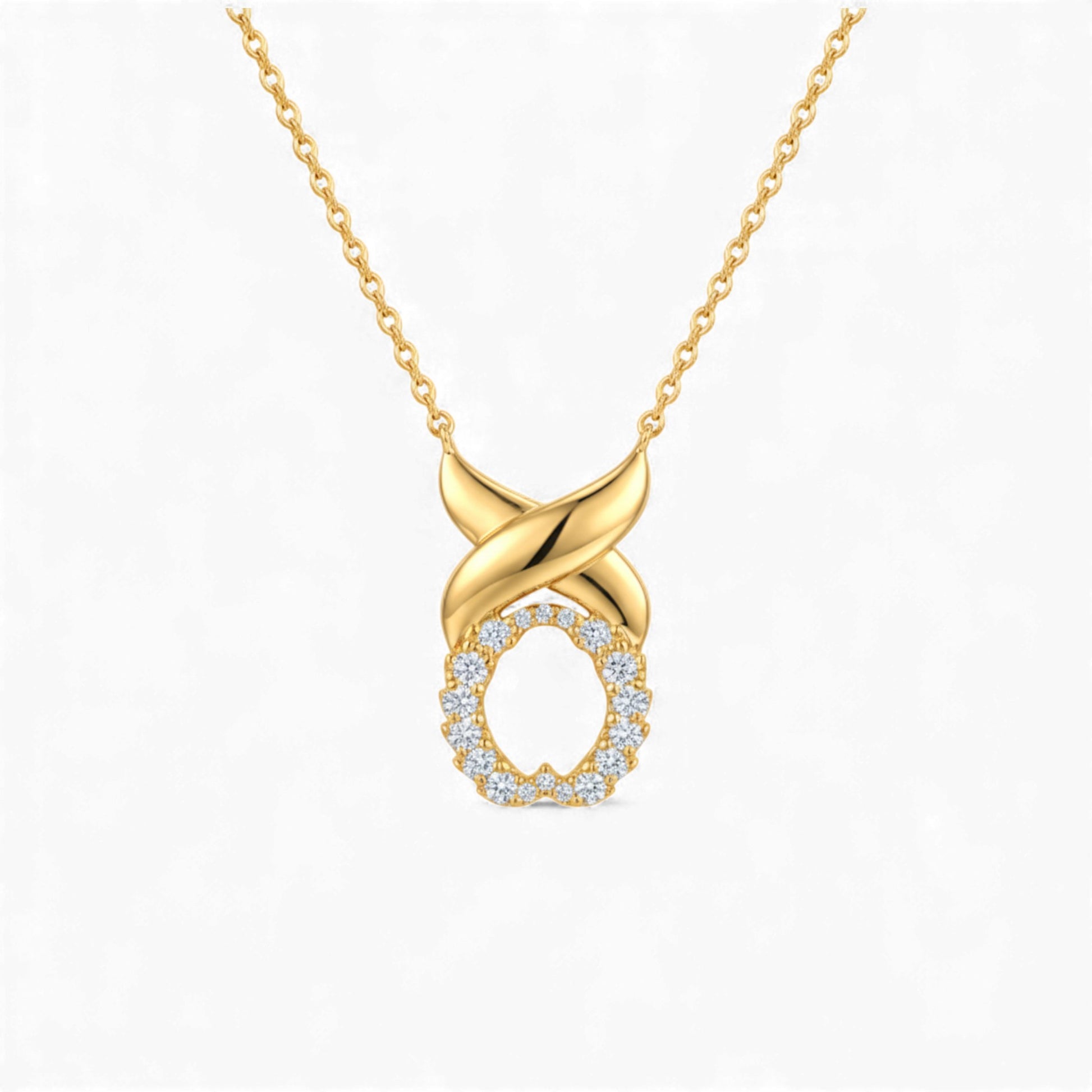 Gold necklace with a diamond-encrusted pendant on a white background