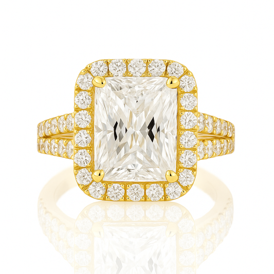 Gold ring with a large central diamond and smaller diamonds around on a white background