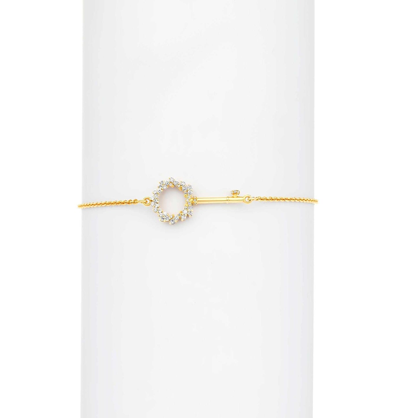 Gold bracelet with a circular design on a white background