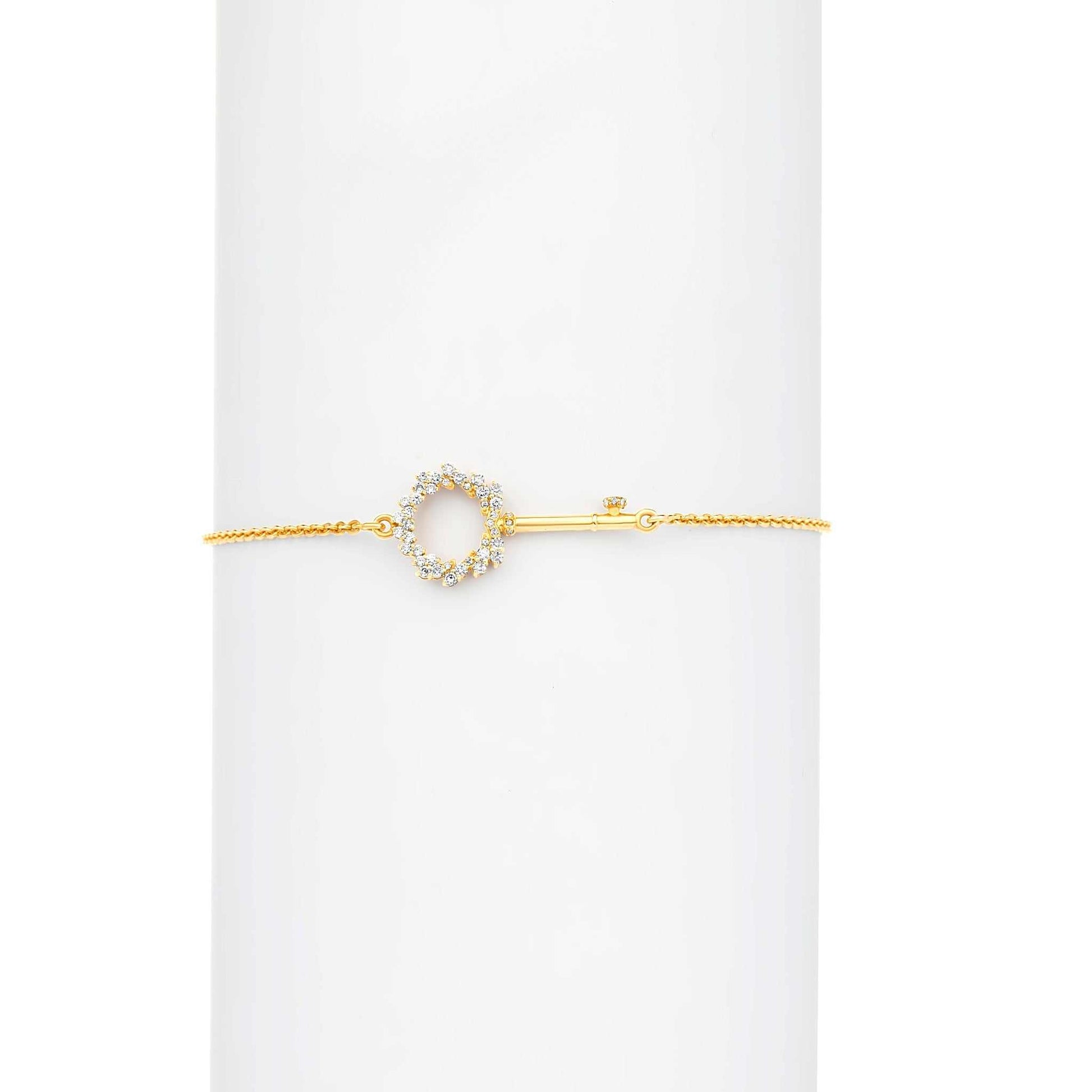 Gold bracelet with a circular design on a white background