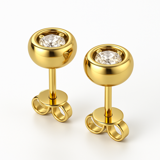 Pair of gold earrings with clear gemstones on a white background