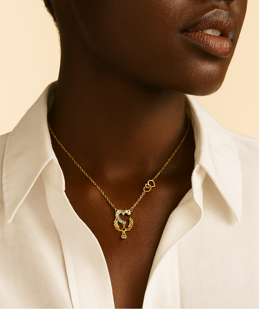 Woman wearing a gold necklace with a white shirt on a beige background